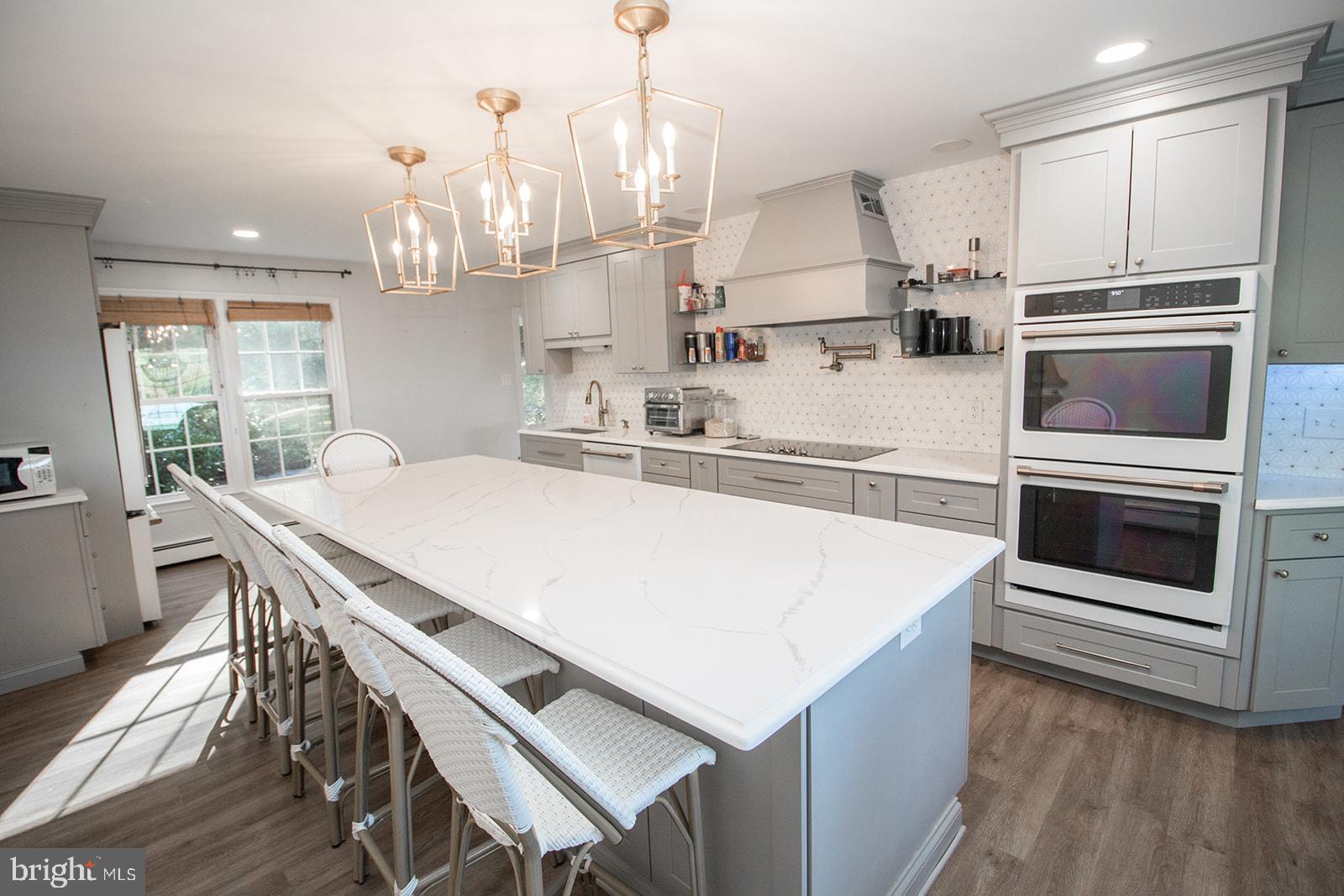 8120 Chapel Point Road Port Tobacco, MD 20677 - Photo 13 of 95 a kitchen with kitchen island a stove a table and chairs in it