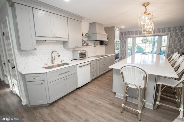 a view of a livingroom with wooden floor and furniture