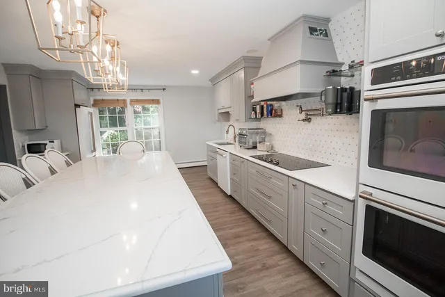 a bedroom with a bed and a mirror on dresser