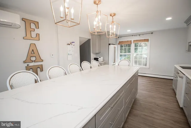 a bedroom with a bed dresser and a window