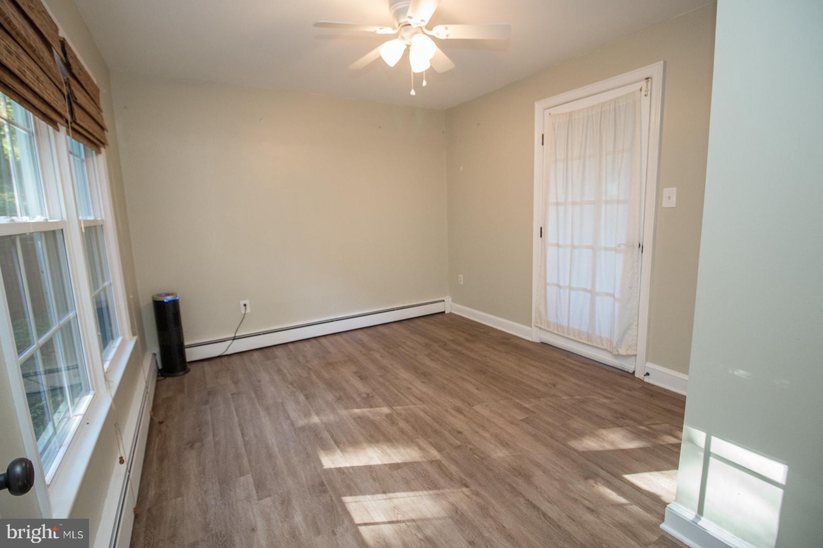 8120 Chapel Point Road Port Tobacco, MD 20677 - Photo 34 of 95 a view of an empty room with wooden floor and a window