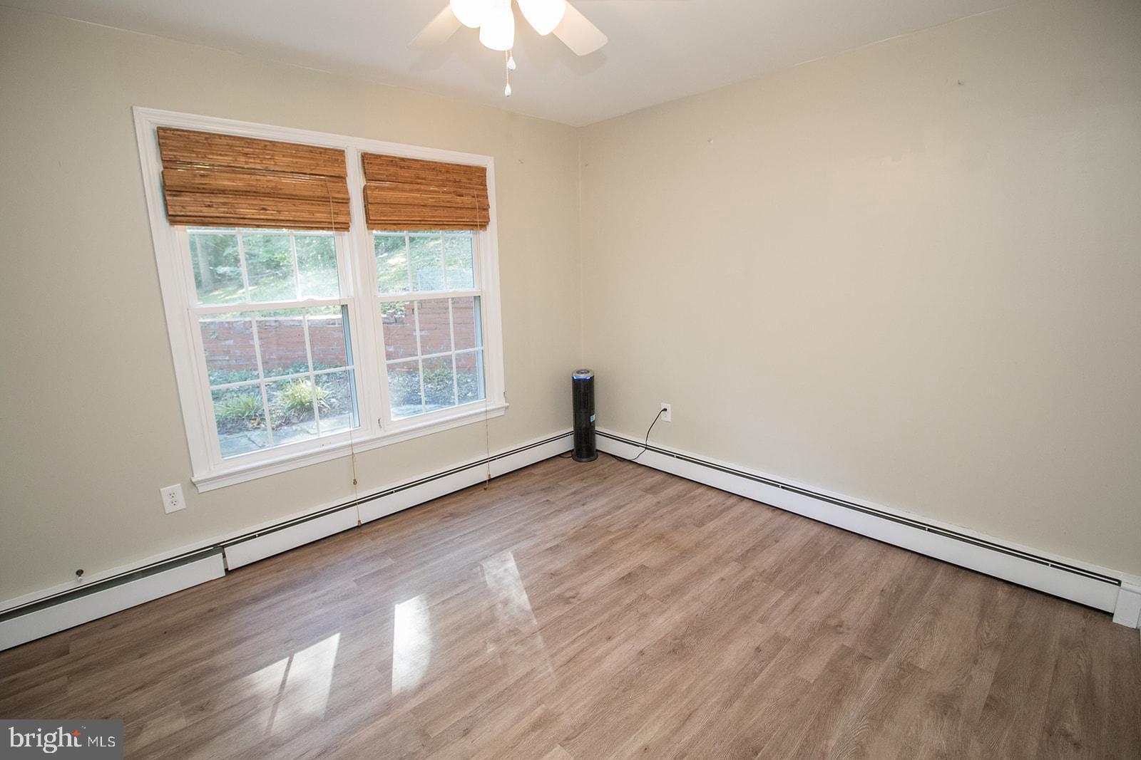 8120 Chapel Point Road Port Tobacco, MD 20677 - Photo 36 of 95 a view of an empty room with wooden floor and a window