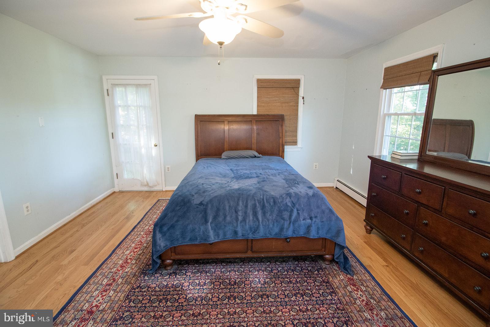 8120 Chapel Point Road Port Tobacco, MD 20677 - Photo 40 of 95 a bedroom with a bed and a mirror on dresser