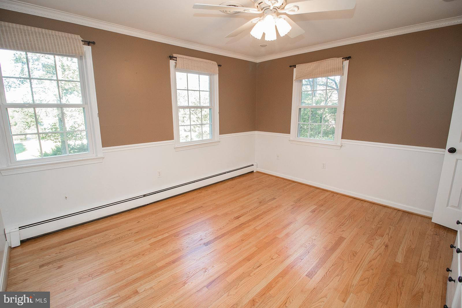 8120 Chapel Point Road Port Tobacco, MD 20677 - Photo 44 of 95 an empty room with wooden floor and windows