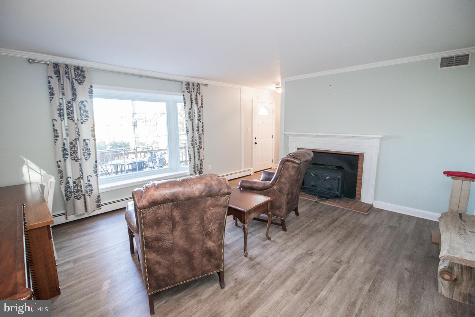 8120 Chapel Point Road Port Tobacco, MD 20677 - Photo 6 of 95 a living room with furniture and a fireplace