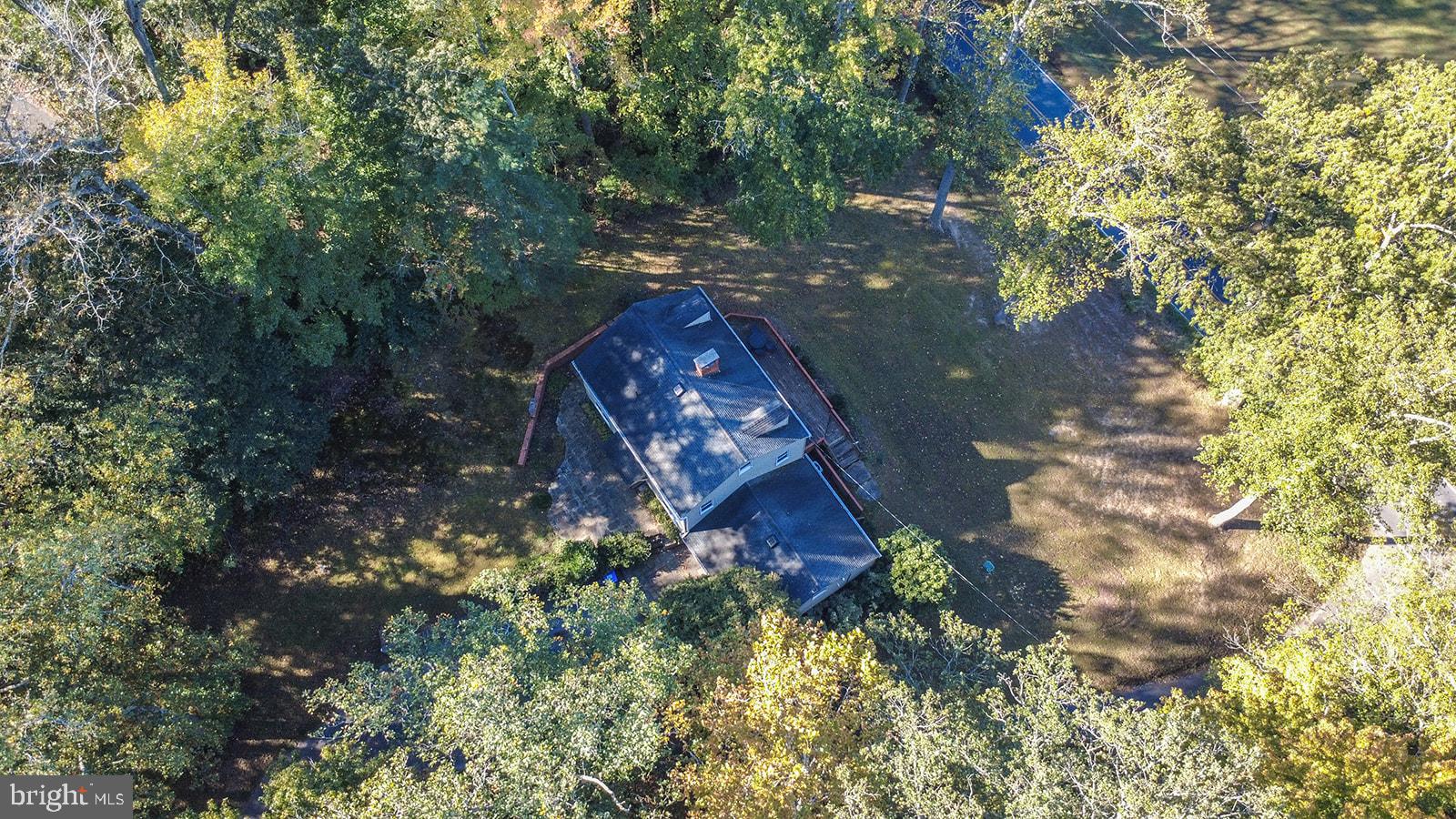 8120 Chapel Point Road Port Tobacco, MD 20677 - Photo 86 of 95 a aerial view of a house with a yard and large trees