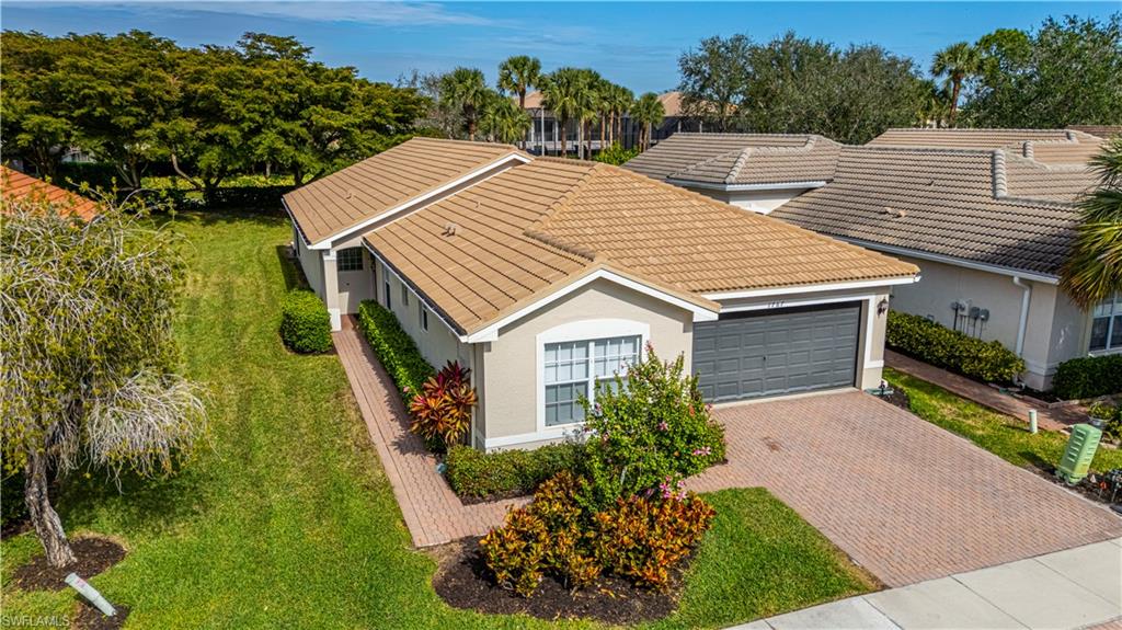 1767 Ribbon Fan Lane Naples, FL 34119 - Photo 1 of 31 View of front facade with a garage and a front yard