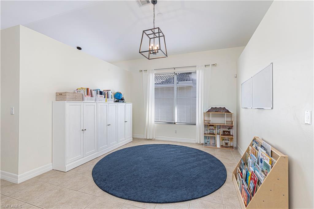 1767 Ribbon Fan Lane Naples, FL 34119 - Photo 12 of 31 Misc room with light tile patterned floors and a notable chandelier