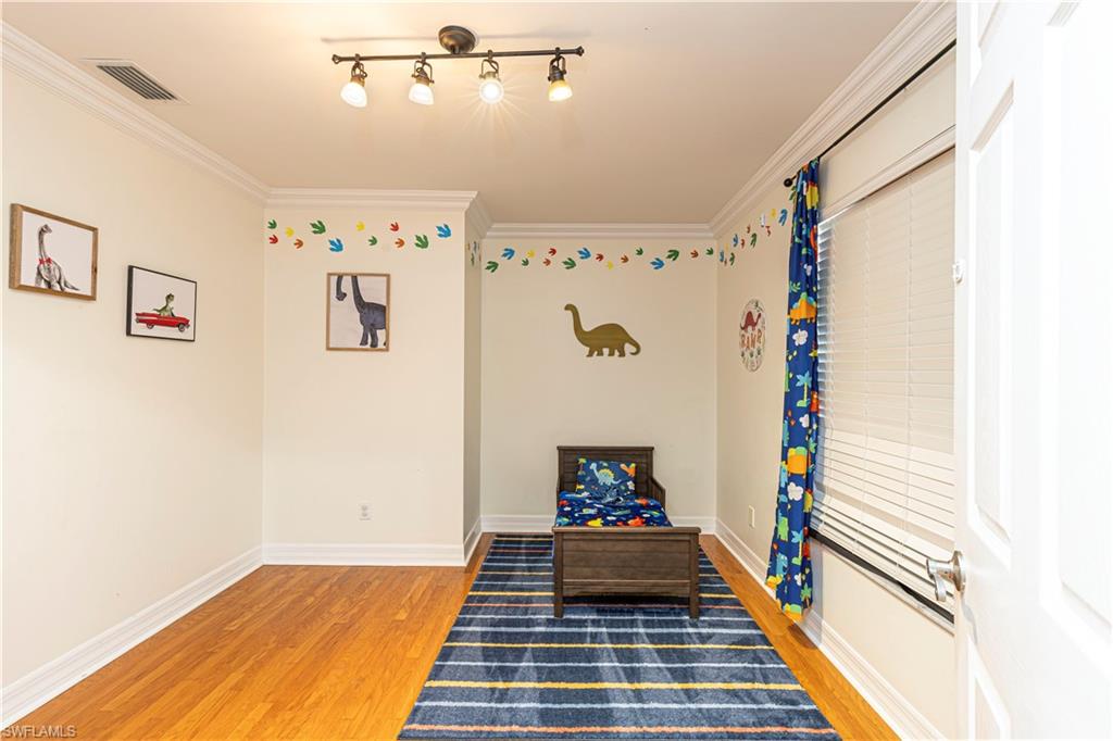 1767 Ribbon Fan Lane Naples, FL 34119 - Photo 16 of 31 Game room featuring crown molding and hardwood / wood-style floors