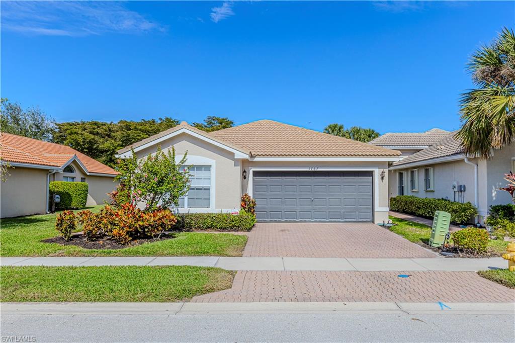 1767 Ribbon Fan Lane Naples, FL 34119 - Photo 17 of 31 View of front of home featuring a garage