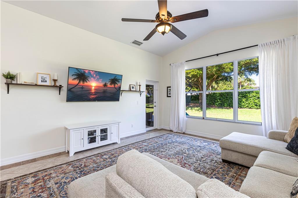1767 Ribbon Fan Lane Naples, FL 34119 - Photo 4 of 31 Living room with ceiling fan, tile patterned floors, and lofted ceiling