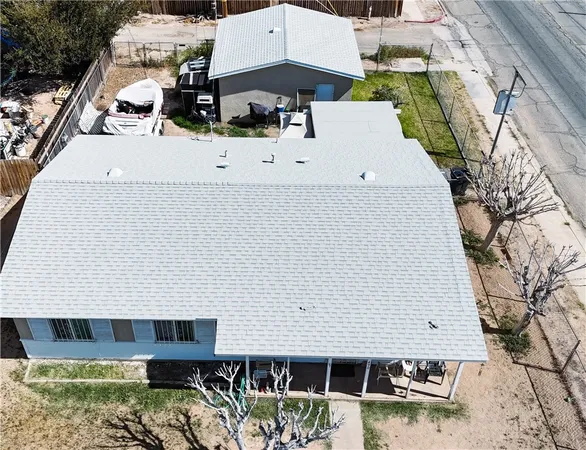 an aerial view of a house with swimming pool and porch