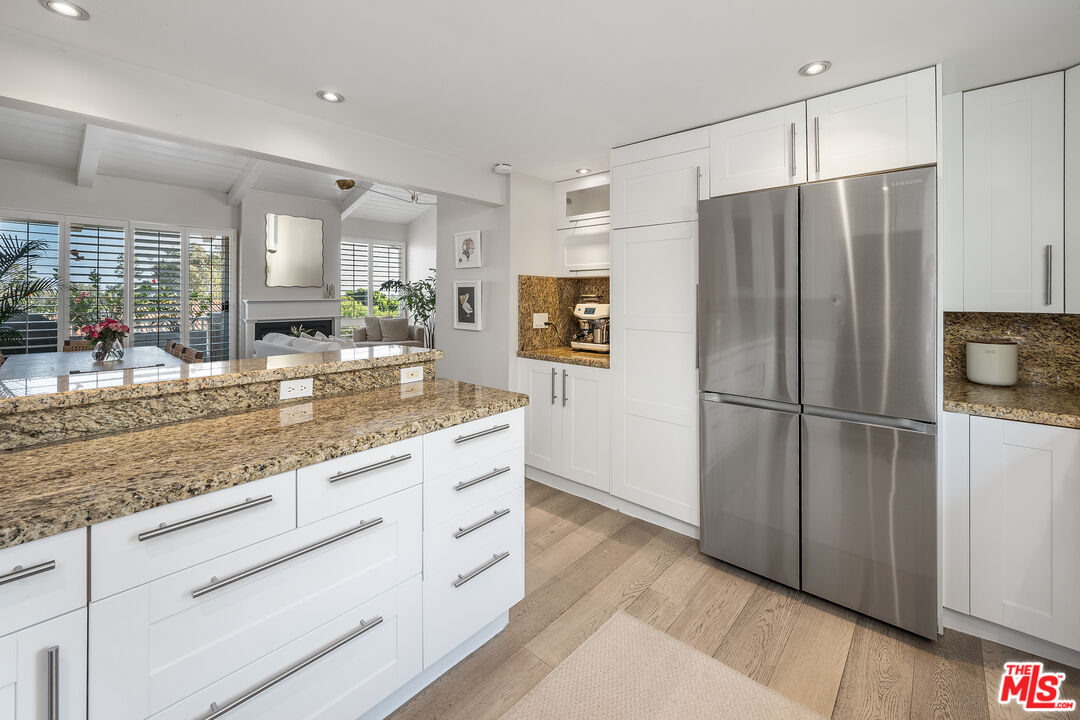 28378 Rey De Copas Lane Malibu, CA 90265 - Photo 16 of 45 a kitchen with stainless steel appliances granite countertop a refrigerator and a sink