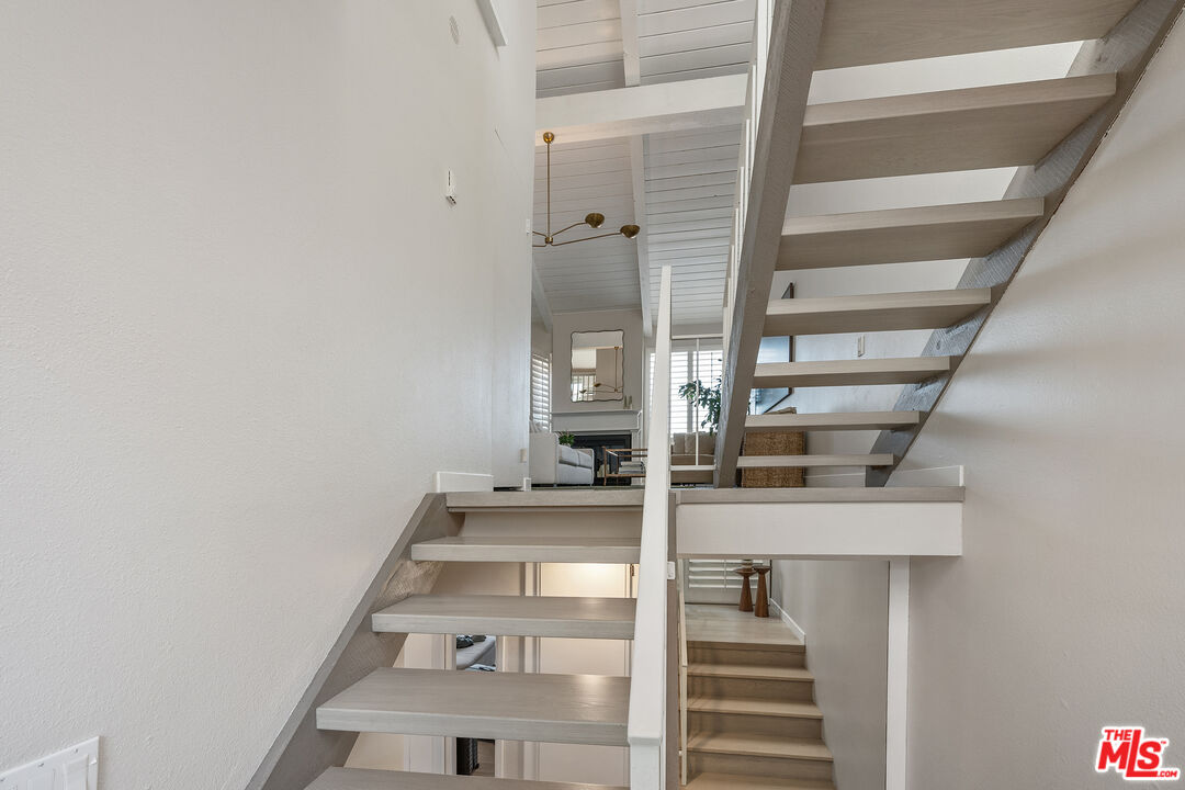 28378 Rey De Copas Lane Malibu, CA 90265 - Photo 26 of 45 a view of staircase with white walls and windows