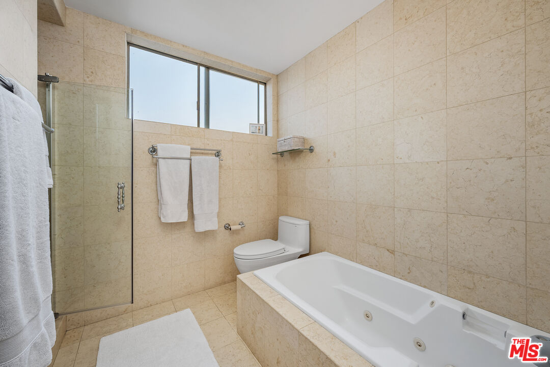 28378 Rey De Copas Lane Malibu, CA 90265 - Photo 30 of 45 a bathroom with a sink a toilet and shower