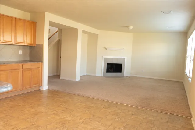 a view of empty room with window and fireplace
