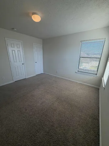 a view of an empty room and a window