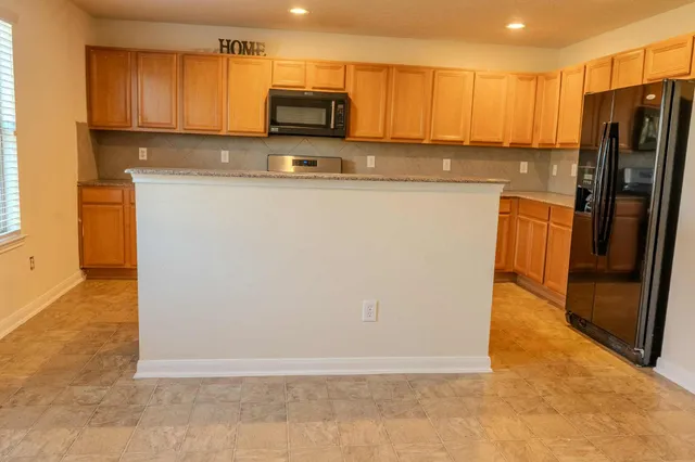 a kitchen with stainless steel appliances a refrigerator stove microwave and sink