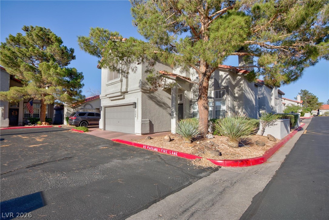 2246 Ramsgate Drive Henderson, NV 89074 - Photo 2 of 36 A welcoming front exterior offers a seamless blend of convenience and low-maintenance landscaping.