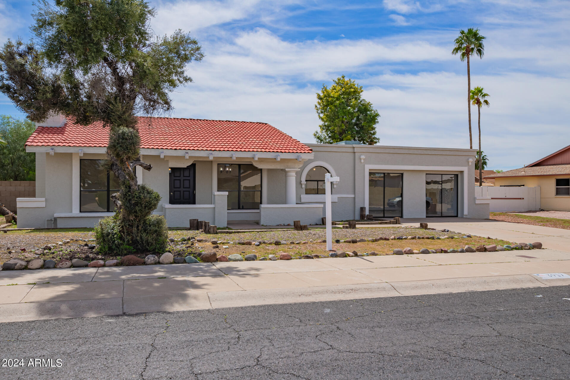 3917 West Juniper Avenue Phoenix, AZ 85053 - Photo 2 of 44 a front view of a house with a garden