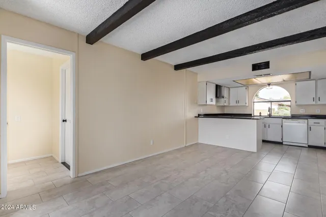 a view of kitchen with white cabinets