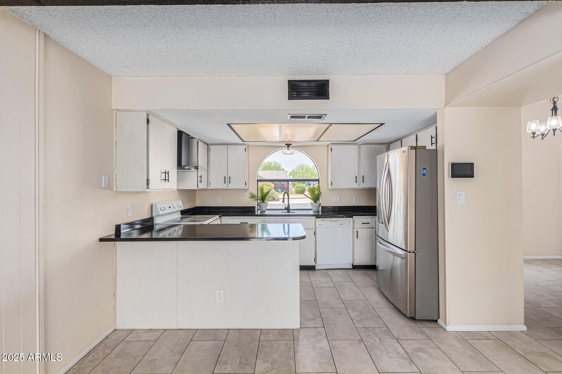 3917 West Juniper Avenue Phoenix, AZ 85053 - Photo 22 of 44 a kitchen with a refrigerator and a stove
