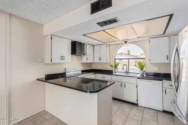 a kitchen that has a sink and a stove in it