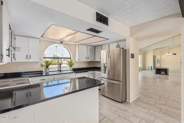 a kitchen with stainless steel appliances a stove a sink and a refrigerator