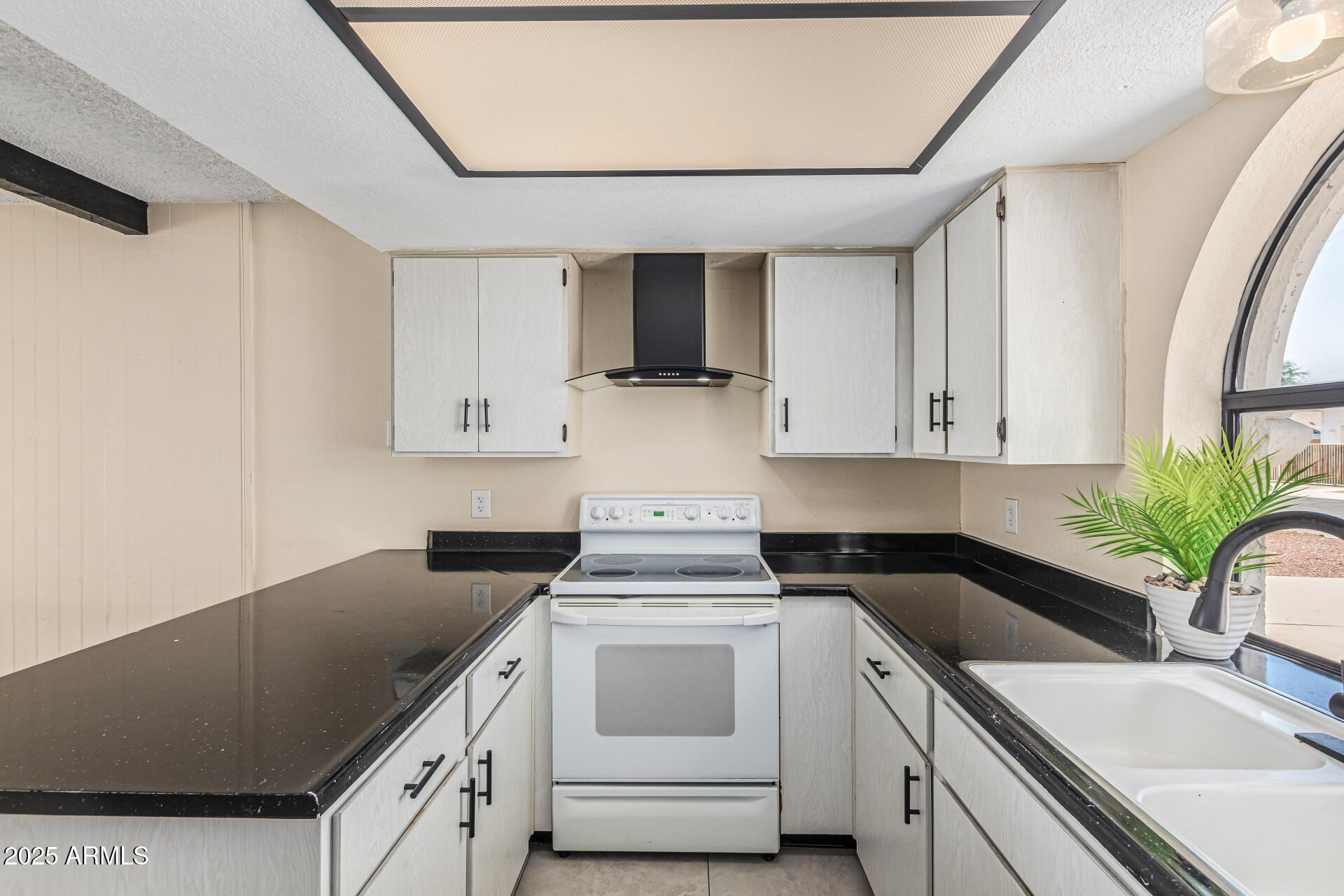 3917 West Juniper Avenue Phoenix, AZ 85053 - Photo 25 of 44 a kitchen with white cabinets and white appliances