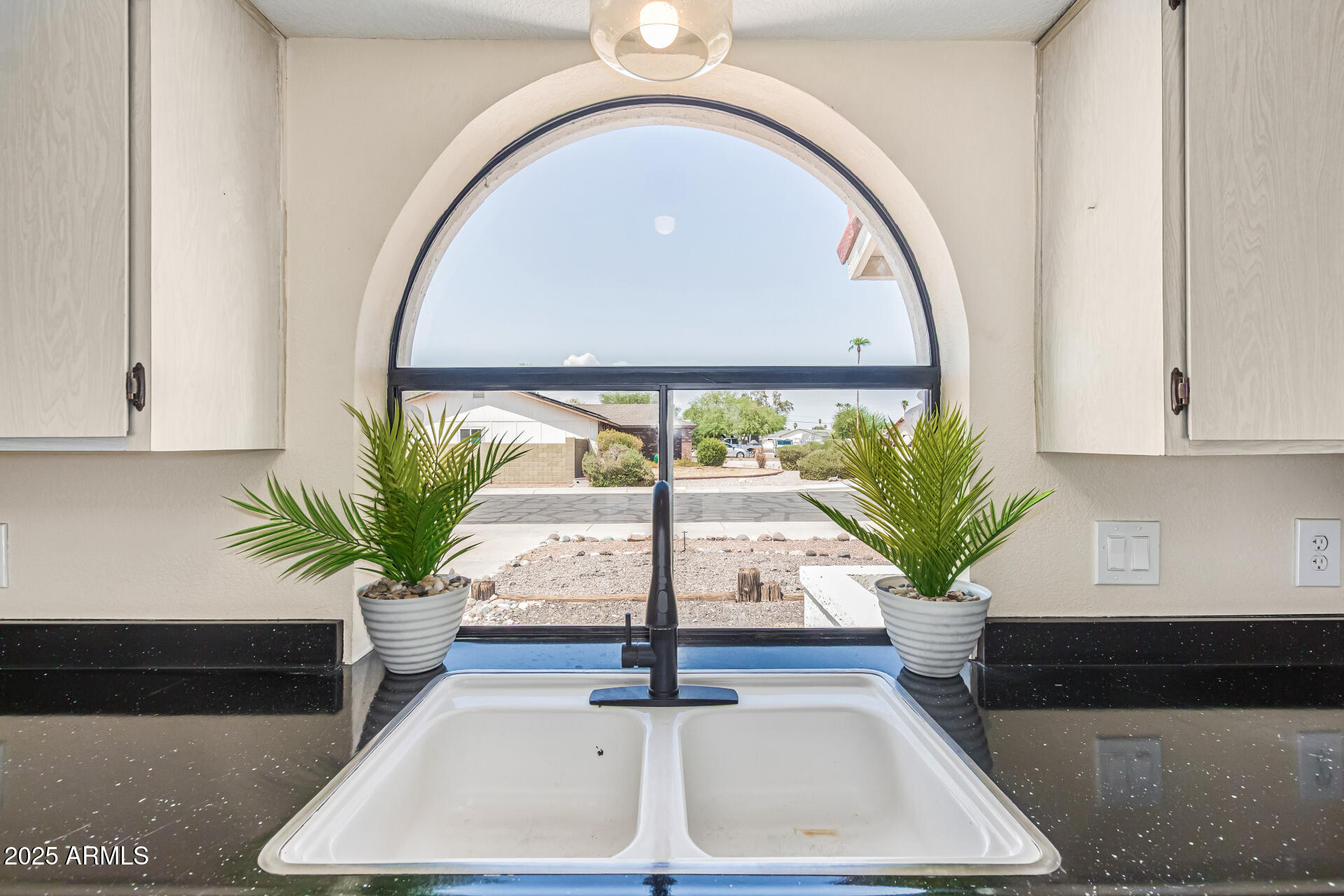 3917 West Juniper Avenue Phoenix, AZ 85053 - Photo 26 of 44 a vase of flowers sitting on a table with window