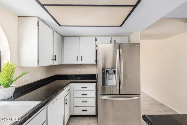 a kitchen with cabinets and stainless steel appliances