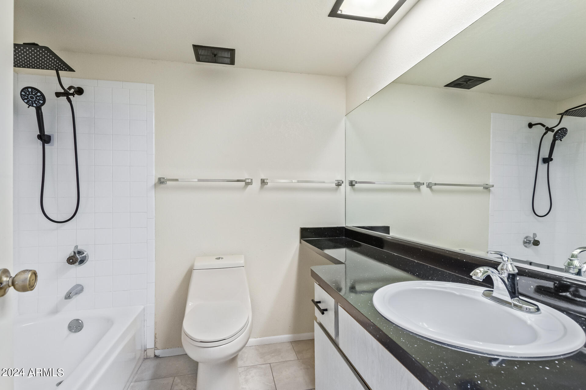 3917 West Juniper Avenue Phoenix, AZ 85053 - Photo 35 of 44 a bathroom with a granite countertop sink a toilet and shower