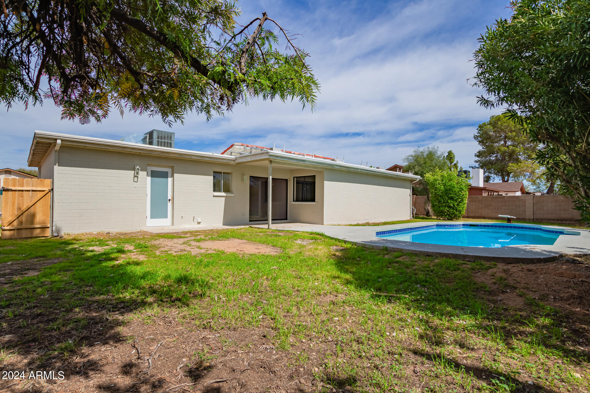 3917 West Juniper Avenue Phoenix, AZ 85053 - Photo 39 of 44 a view of a white house with a yard and large tree