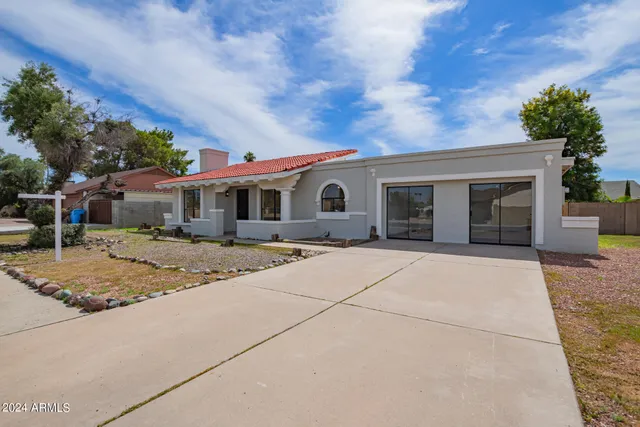 a front view of house with yard garage and green space