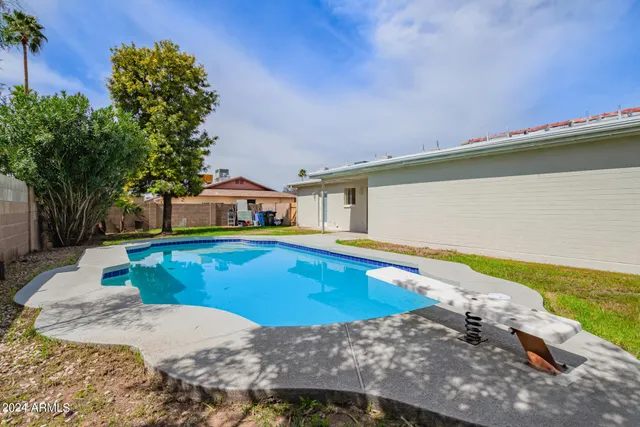 a view of a swimming pool with a yard