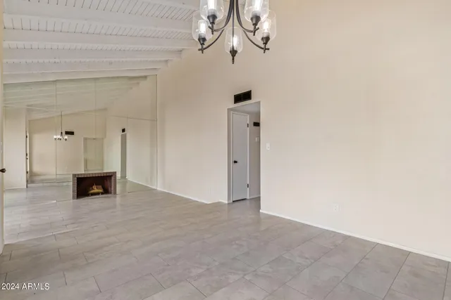 a view of an empty room with a chandelier