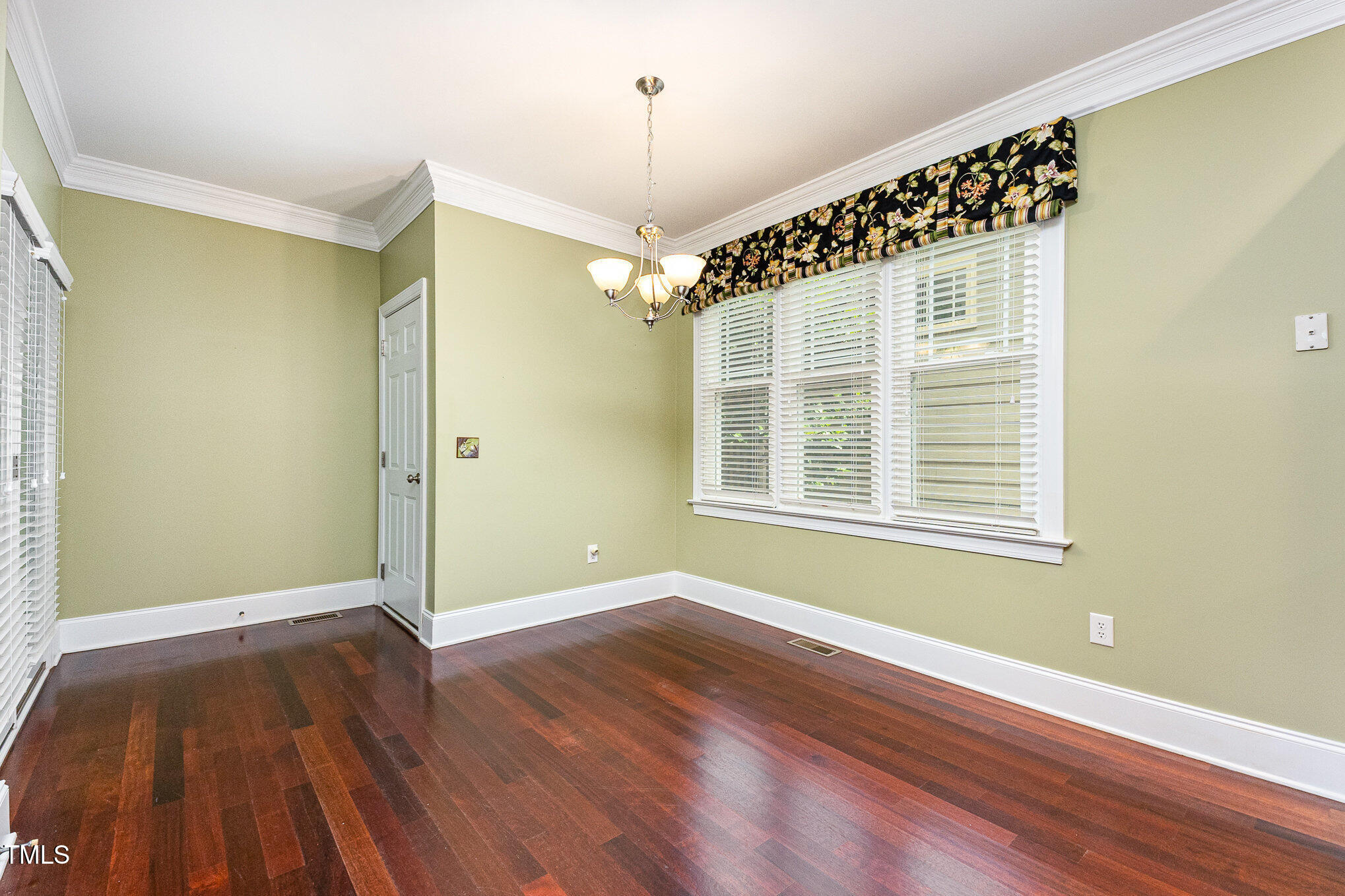 2201 Karns Place Raleigh, NC 27614 - Photo 13 of 31 a view of an empty room with wooden floor and a window