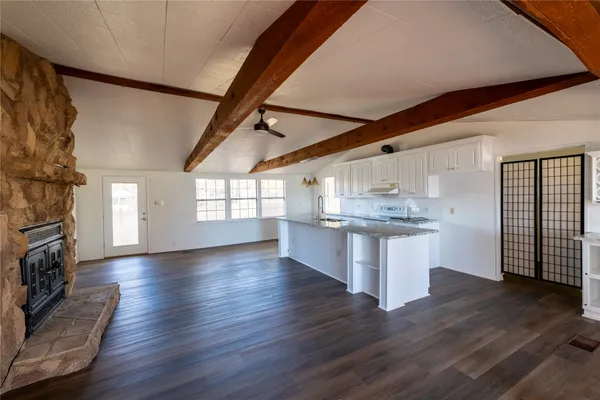 a view of kitchen and hall with wooden floor