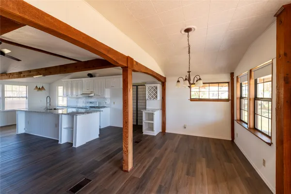 a kitchen with a hard wood floor