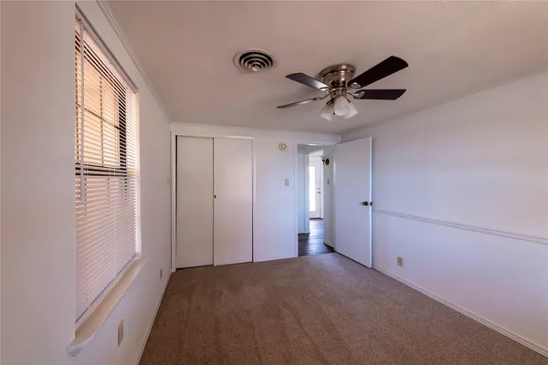 a view of a livingroom with a ceiling fan and window