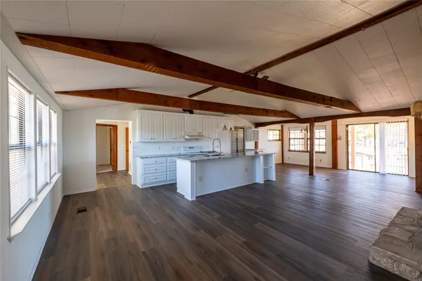 a view of a kitchen with a sink and wooden floor