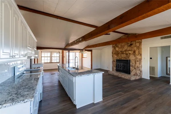 a view of a kitchen with a sink and a fireplace