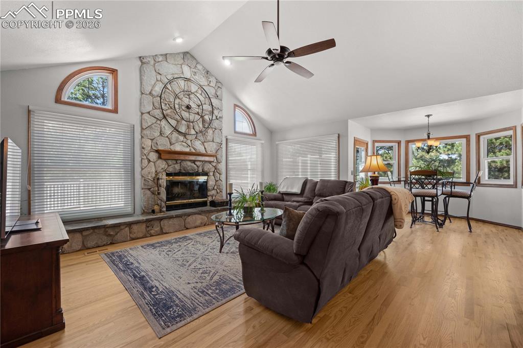 17815 Saddlewood Road Monument, CO 80132 - Photo 11 of 40 a living room with furniture and a fireplace