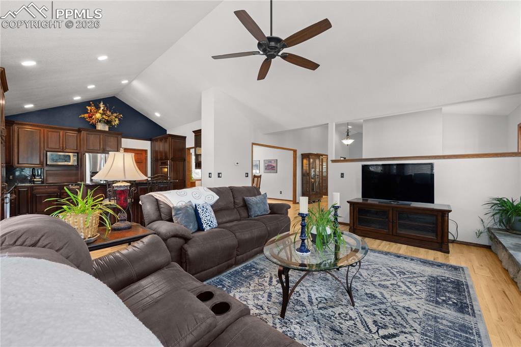 17815 Saddlewood Road Monument, CO 80132 - Photo 14 of 40 a living room with furniture and a flat screen tv