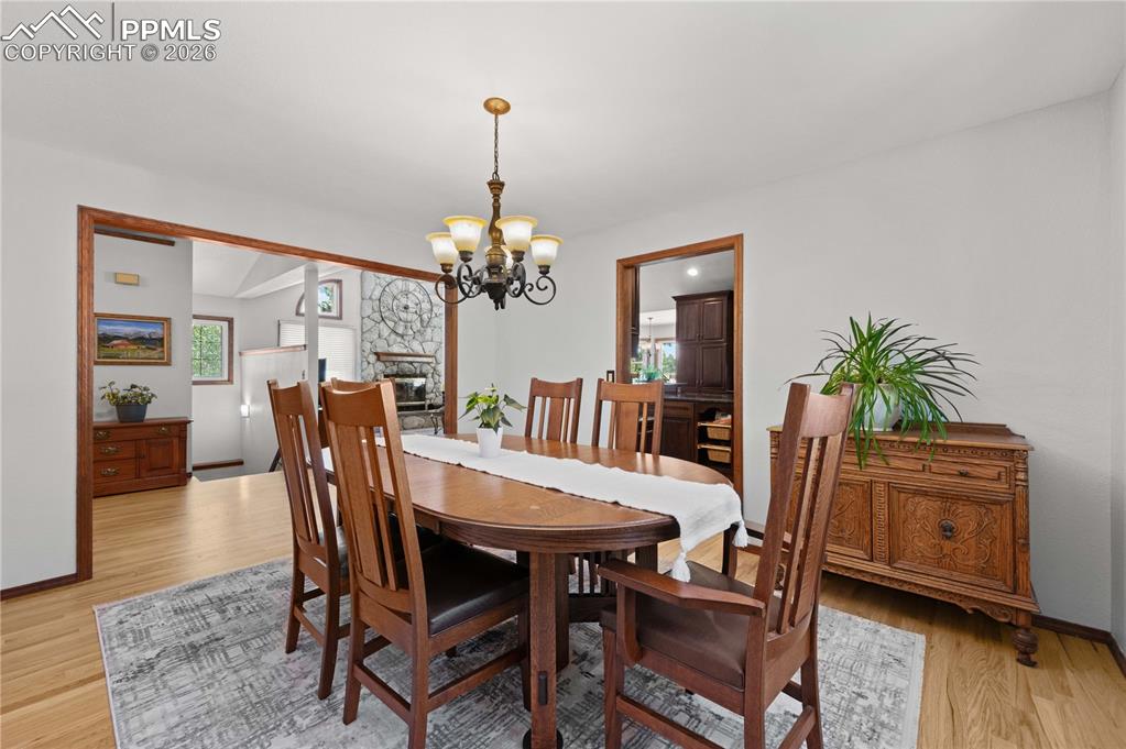17815 Saddlewood Road Monument, CO 80132 - Photo 16 of 40 a view of a dining room with furniture window and wooden floor