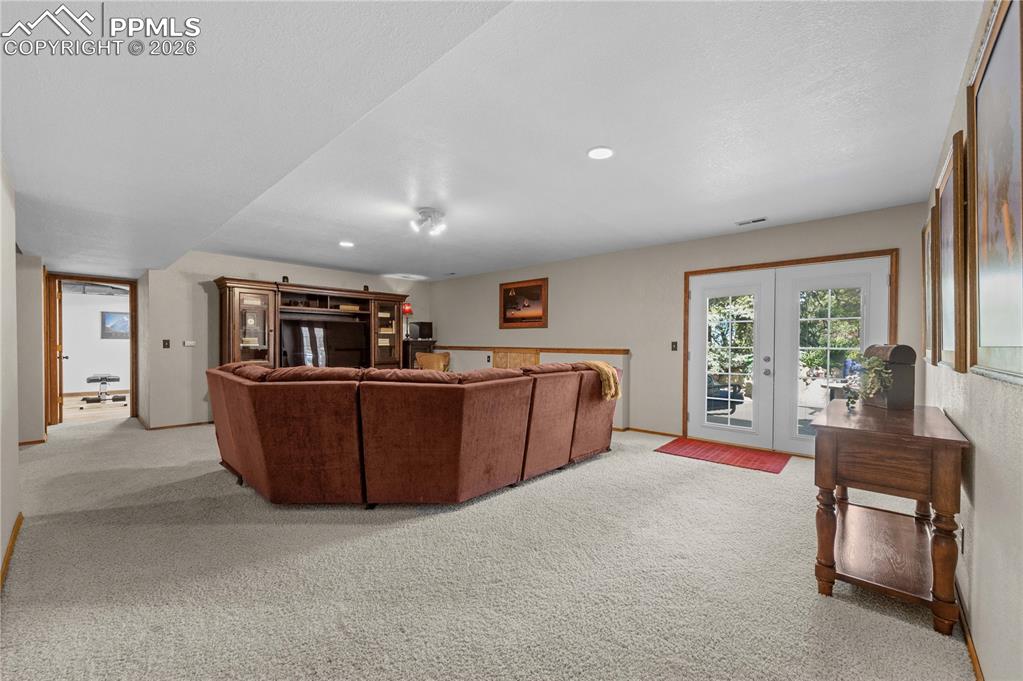17815 Saddlewood Road Monument, CO 80132 - Photo 28 of 40 a living room with furniture and a flat screen tv