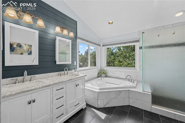 a view of a patio with table and chairs and wooden fence