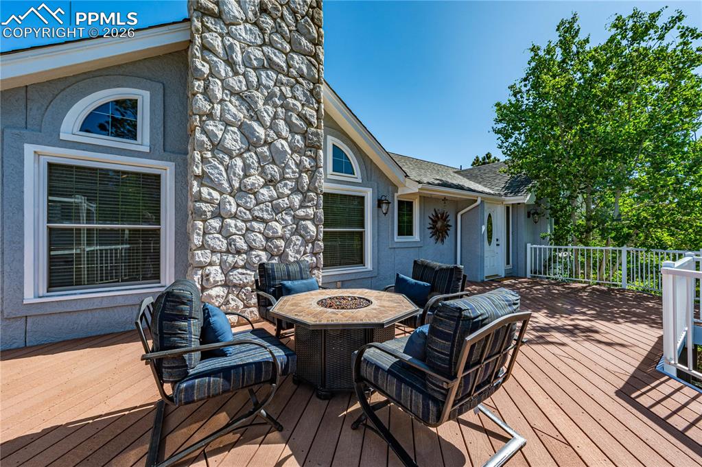17815 Saddlewood Road Monument, CO 80132 - Photo 34 of 40 a view of a patio with table and chairs and wooden fence