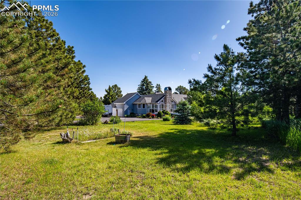 17815 Saddlewood Road Monument, CO 80132 - Photo 37 of 40 a swimming pool with big trees