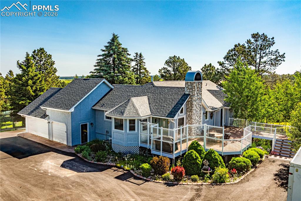 17815 Saddlewood Road Monument, CO 80132 - Photo 4 of 40 a view of a house with garden and yard
